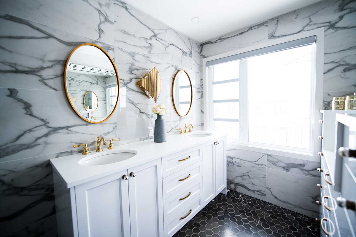 beautiful marble bathroom with gold accent mirrors