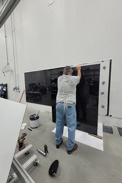 staff installing glass panels